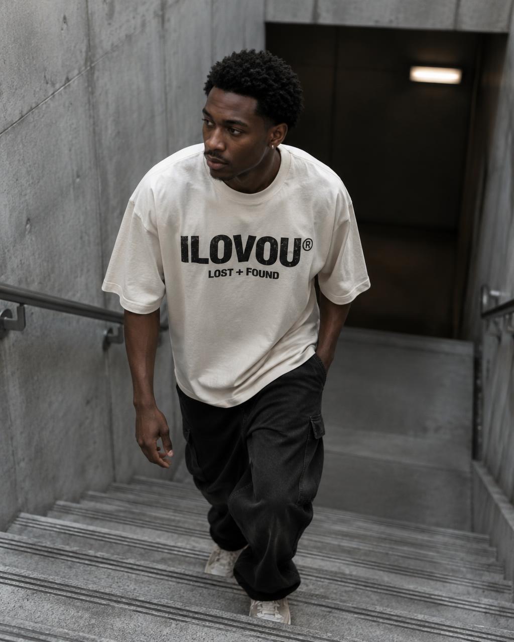 Man wearing the bone Lost + Found tee on concrete stairs