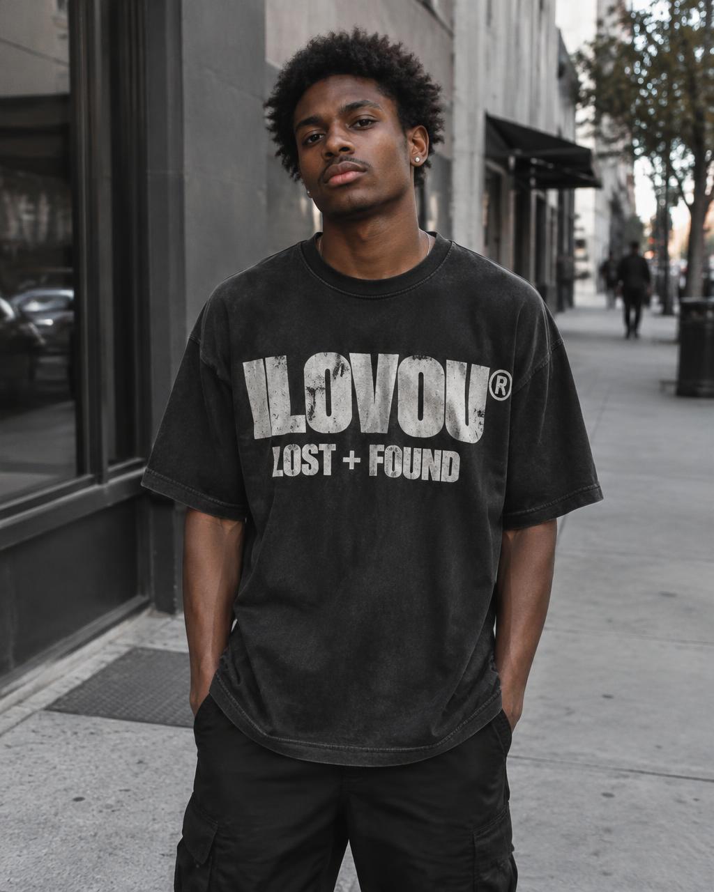 Man wearing the washed black Lost + Found tee on a city sidewalk
